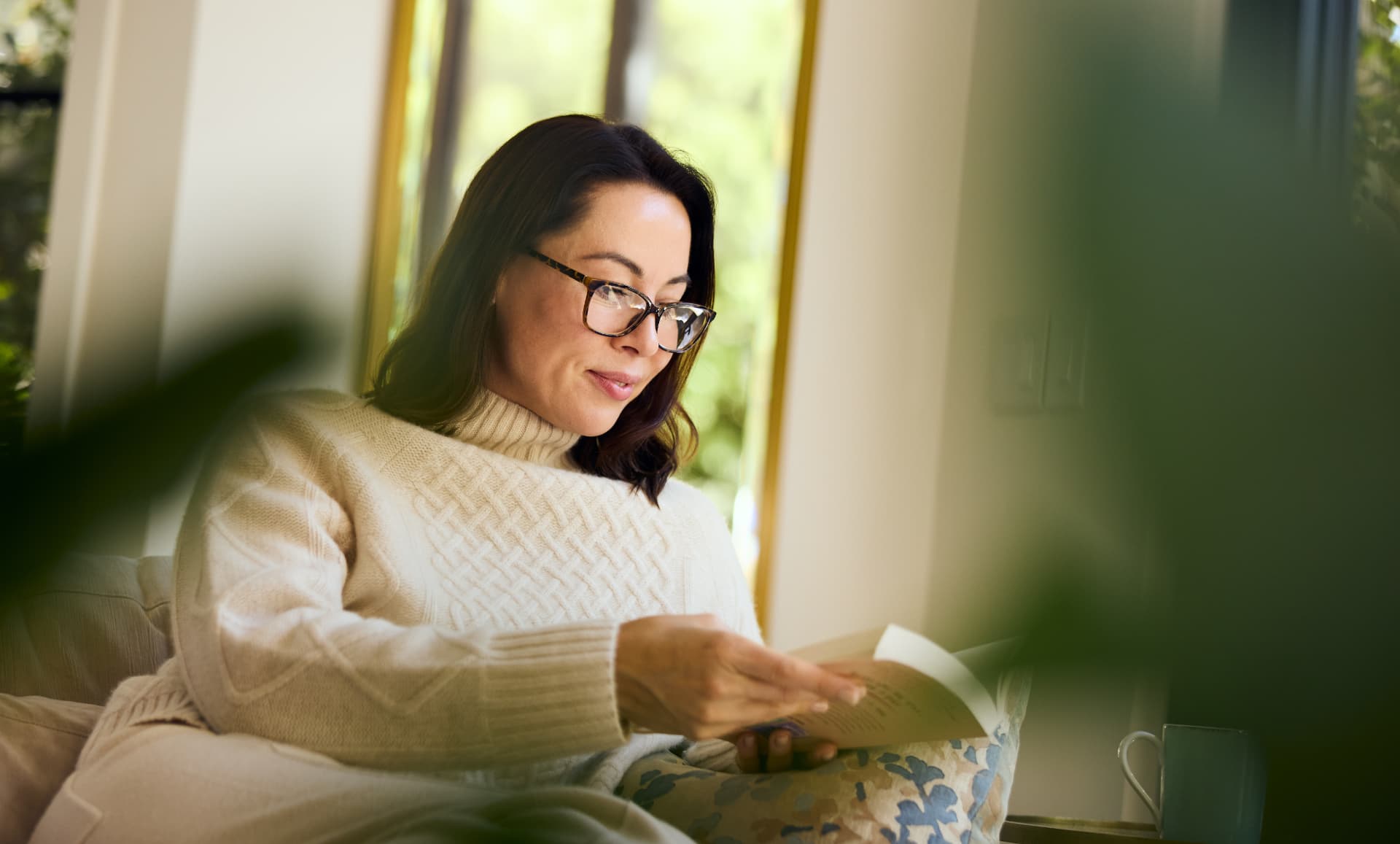 Woman reading comfortably at home after vision correction